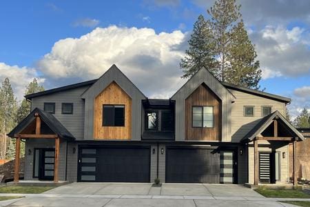 A row of houses with garage doors in front.