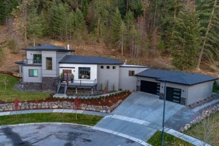 A house with a driveway and garage in the middle of it.