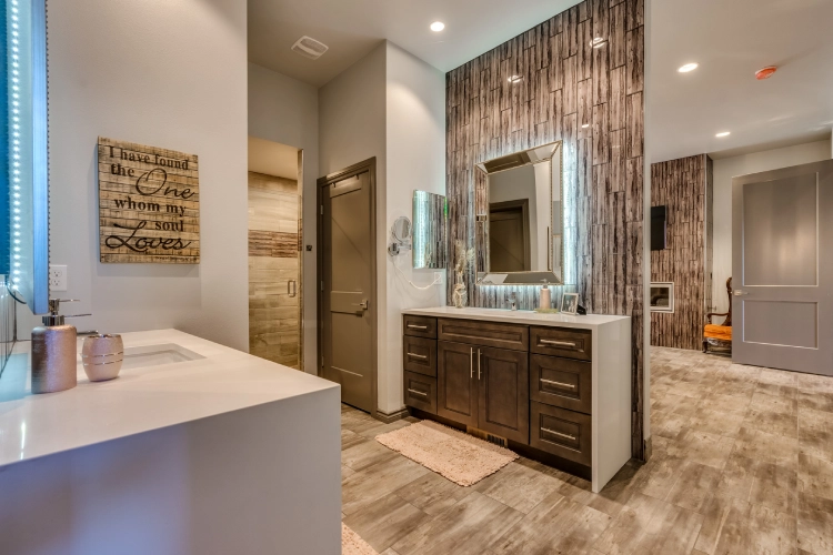 A bathroom with wood paneling and tile floors.