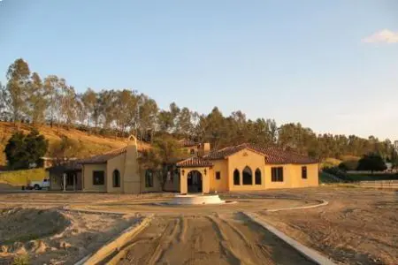 A large building with a driveway in front of it.