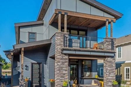 A large house with many windows and a balcony.